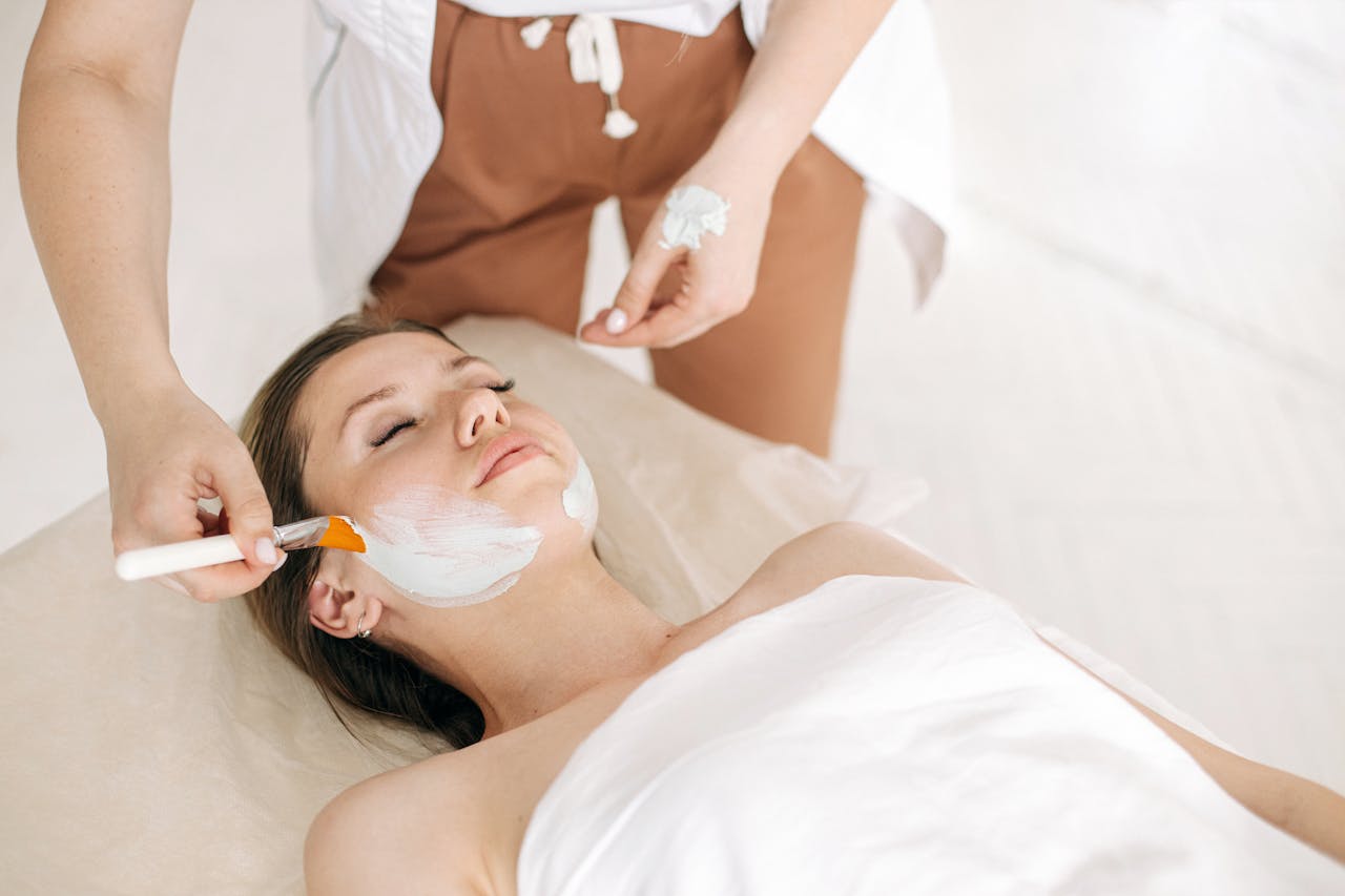 Home Woman receiving a rejuvenating facial treatment at a spa, promoting skin care and relaxation.